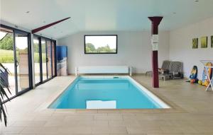 a large swimming pool in a living room with at Amazing Home In Elliant in Elliant