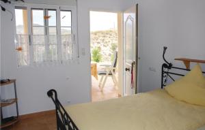 a bedroom with a bed and a door to a patio at Amazing Home In Monnegre With 3 Bedrooms in Monnegre de Arriba