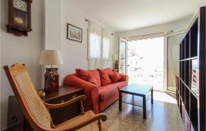 a living room with a red couch and a table at Amazing Apartment In Altea With 2 Bedrooms in Altea