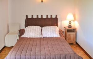 a bed with two pillows on it in a bedroom at Gorgeous Home In Durfort Capelette in Durfort