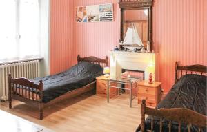 a bedroom with two beds and a mirror at Amazing Home In Morlaix With Wifi in Sainte-Geneviève