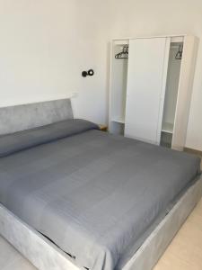 a large bed in a room with two sliding doors at Casa via Garibaldi in Leverano