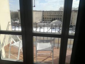 a view from a window of a balcony with two chairs at Smolna 9 WARSZAWA CENTRUM in Warsaw