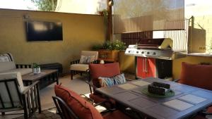 a patio with a table and chairs and a stove at Private, Quite Casita , N. Scottsdale area,Private Pool & Patio, Cave Creek Az. in Cave Creek