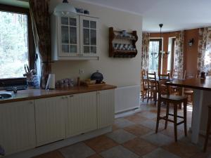 a kitchen with white cabinets and a counter top at Raduńska Ostoja in Dziemiany