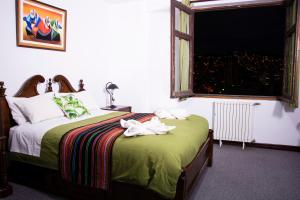 a bedroom with a bed with towels on it at Inca's Room in La Paz