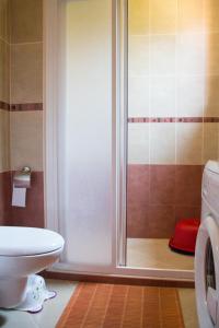 a bathroom with a shower with a toilet and a washing machine at Santa Marina,Sozopol,apt.901-43 in Sozopol