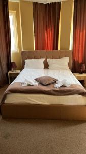a bedroom with a bed with two towels on it at HOTEL THE WHITE HOUSE Plovdiv in Plovdiv