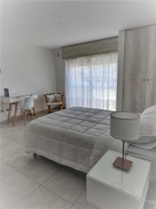 a bedroom with a large bed and a table at Cabrera in Junín
