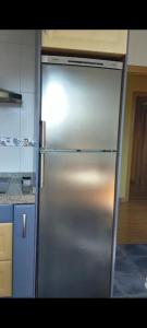 a stainless steel refrigerator in a kitchen at Mirador de Valcayo in Riaño