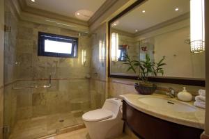 a bathroom with a toilet and a sink and a shower at Villa Senja in Tanah Lot +23 photos