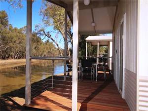 a porch of a house with a view of the water at BIG4 Riverside Swan Hill in Swan Hill