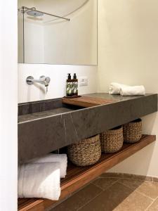a bathroom with a sink and a mirror at Torre Granitola Suite in Granitola
