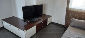 a flat screen tv on a dresser in a room at Sistiana 12/Z-11 Borgo delle Ginestre in Visogliano