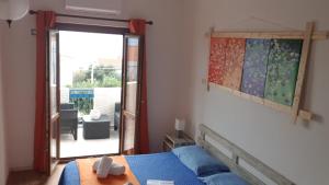 a bedroom with a bed and a window at B&B Cala Luna in Cala Gonone
