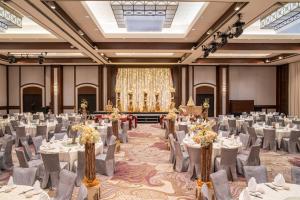a banquet hall with white tables and chairs at Paradox Singapore Merchant Court at Clarke Quay in Singapore +56 photos