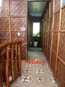 a hallway with a tile floor in a building at RYJ's Inn in Siquijor