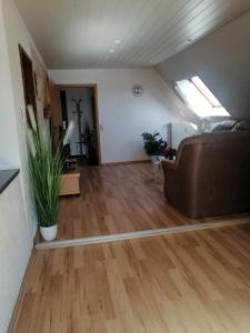 a living room with a couch and wood floors at Haus Weda in Krummhörn