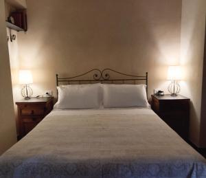 a bedroom with a large bed with two night stands at Locanda del Sale Affittacamere in Genoa