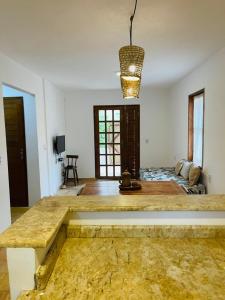 a large room with a table and a bed in it at Apê do Fabiano Flats e lofts in Jericoacoara