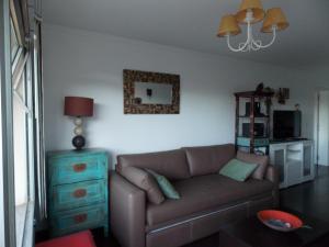 a living room with a couch and a blue dresser at Quintaluna frente al lago in San Carlos de Bariloche