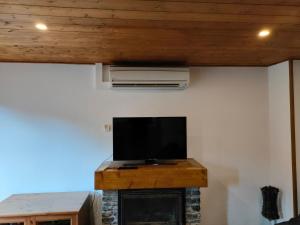 a flat screen tv sitting on top of a fireplace at Apartment in Llavorsi in the heart of the Catalan Pyrenees in Llavorsí