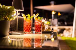 a table topped with two cocktails on a table at Aktiv Panoramahotel Daniel in Sautens