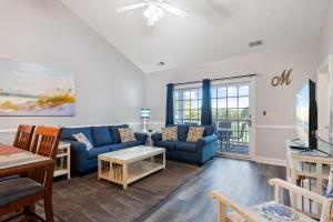 a living room with a couch and a table at Beach at the Greens in Myrtle Beach