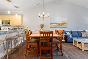 a kitchen and living room with a table and chairs at Beach at the Greens in Myrtle Beach
