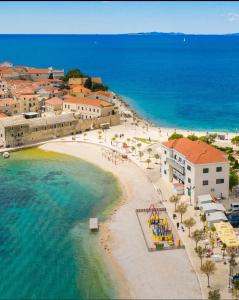 an aerial view of a beach with buildings and the ocean at Apartment Maxim in Primošten