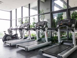 a row of cardio machines in a gym at Tropicana 218 Macalister Netflix High Floor in George Town