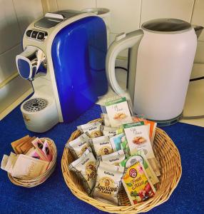 a basket filled with food next to a toaster at Polly's Verona Apartment in Verona