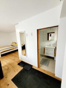 a room with a mirror and a bed and a bathroom at Apartment Sonnenschein in Dornbirn