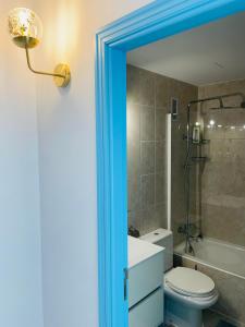 a bathroom with a toilet and a sink and a shower at Blue House Mallorca in Ses Salines