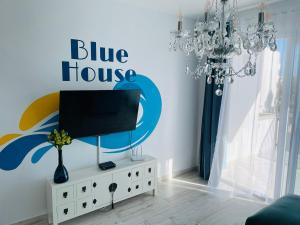 a living room with a tv on a white dresser at Blue House Mallorca in Ses Salines