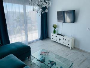 a living room with a blue couch and a glass table at Blue House Mallorca in Ses Salines