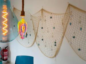 a room with three hanging lights on a wall at Blue House Mallorca in Ses Salines
