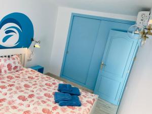 a bedroom with a bed with a blue door at Blue House Mallorca in Ses Salines