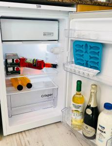 an open refrigerator filled with drinks and alcohol at Blue House Mallorca in Ses Salines