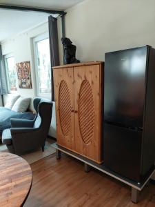 a living room with a black refrigerator and a couch at Studio Mini-Mexiko in Arnsberg