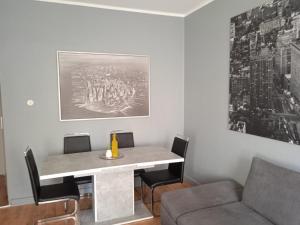 a living room with a table and a couch at Stadtnah an der Förde 7 EG R in Flensburg