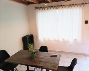a dining room with a wooden table and chairs at La Cantonada in Caviahue +5 photos