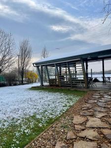 a pavilion with snow on the ground in a park at Divá Kačica Restaurant & Pansion in Komárno