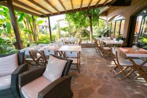 a restaurant with tables and chairs in a patio at Camere Da Kico in Assago