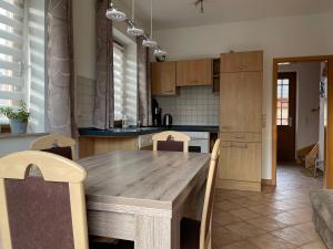 a kitchen with a wooden table and chairs at Ferienwohnung Familie Görtler in Graal-Müritz