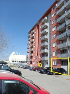 a parking lot with cars parked in front of a building at APARTMAN MARIO - ARENA ZAGREB in Zagreb