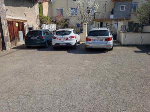 a group of three cars parked in a parking lot at kaon nil in Gerzat