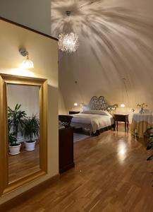 a bedroom with a bed and a large mirror at Residenza Ducale in Bovino