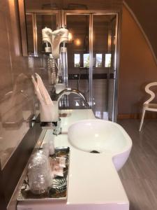 a bathroom with a white sink and a mirror at Residenza Ducale in Bovino