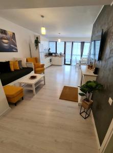 a living room with a couch and a table at Relax Apartment Predeal in Predeal